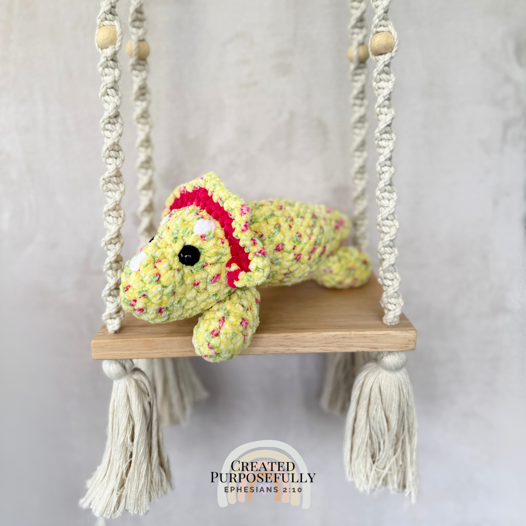 Handmade laying triceratops plush made with soft plush yarn and adorable dinosaur details