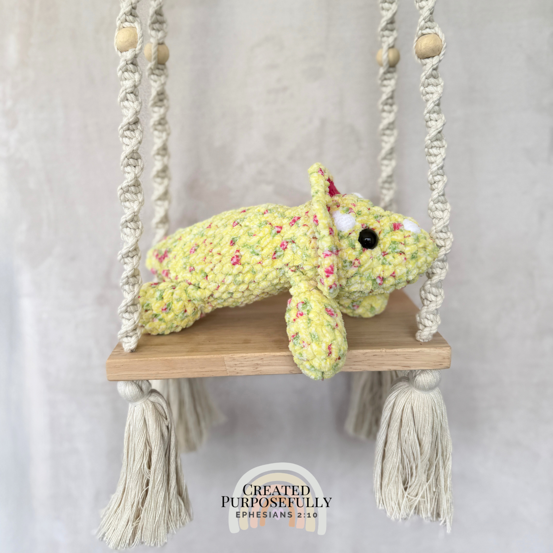Handmade laying triceratops plush made with soft plush yarn and adorable dinosaur details