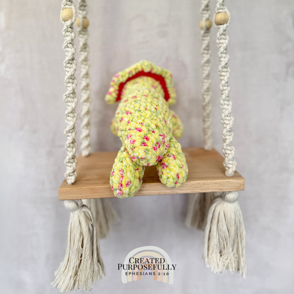 Handmade laying triceratops plush made with soft plush yarn and adorable dinosaur details