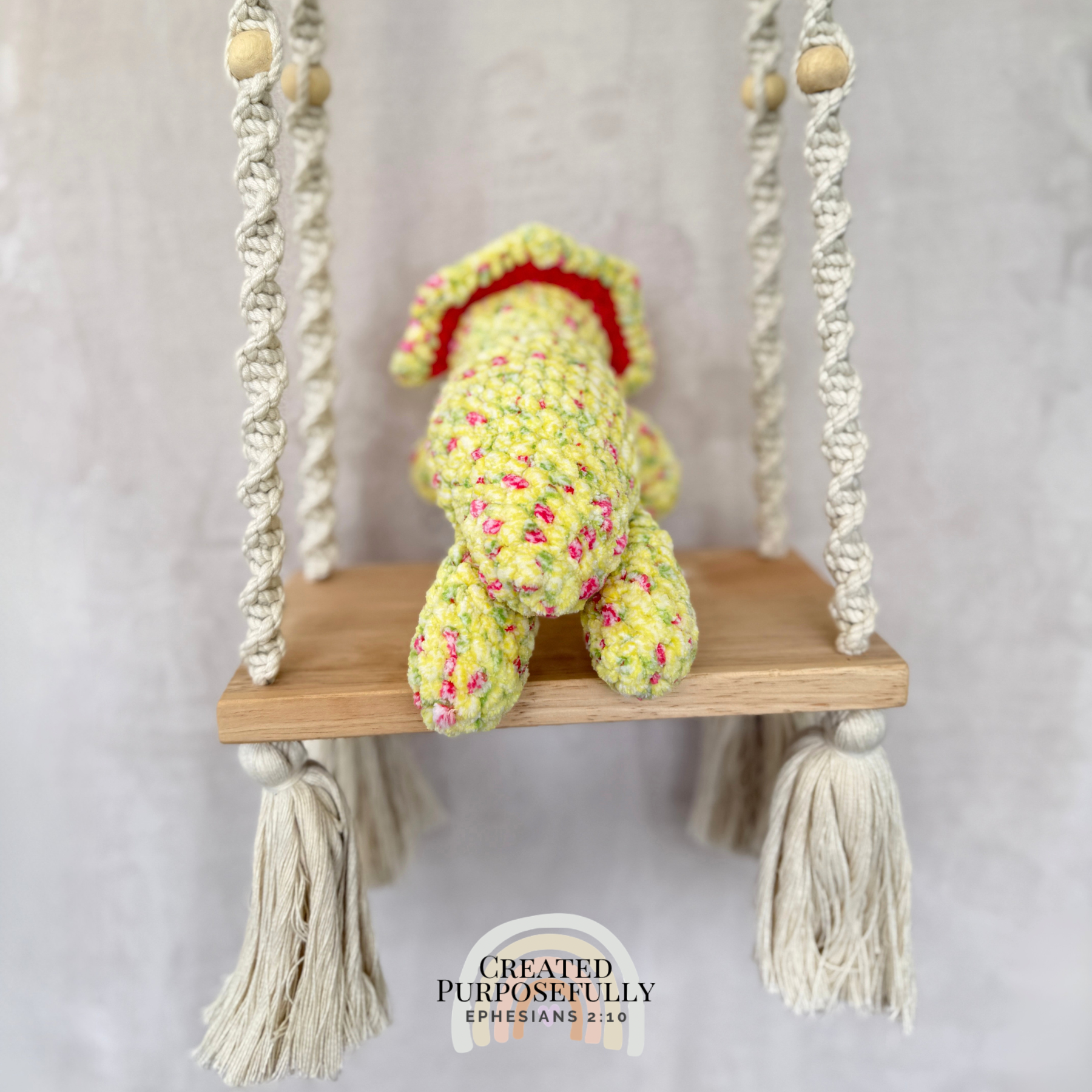 Handmade laying triceratops plush made with soft plush yarn and adorable dinosaur details
