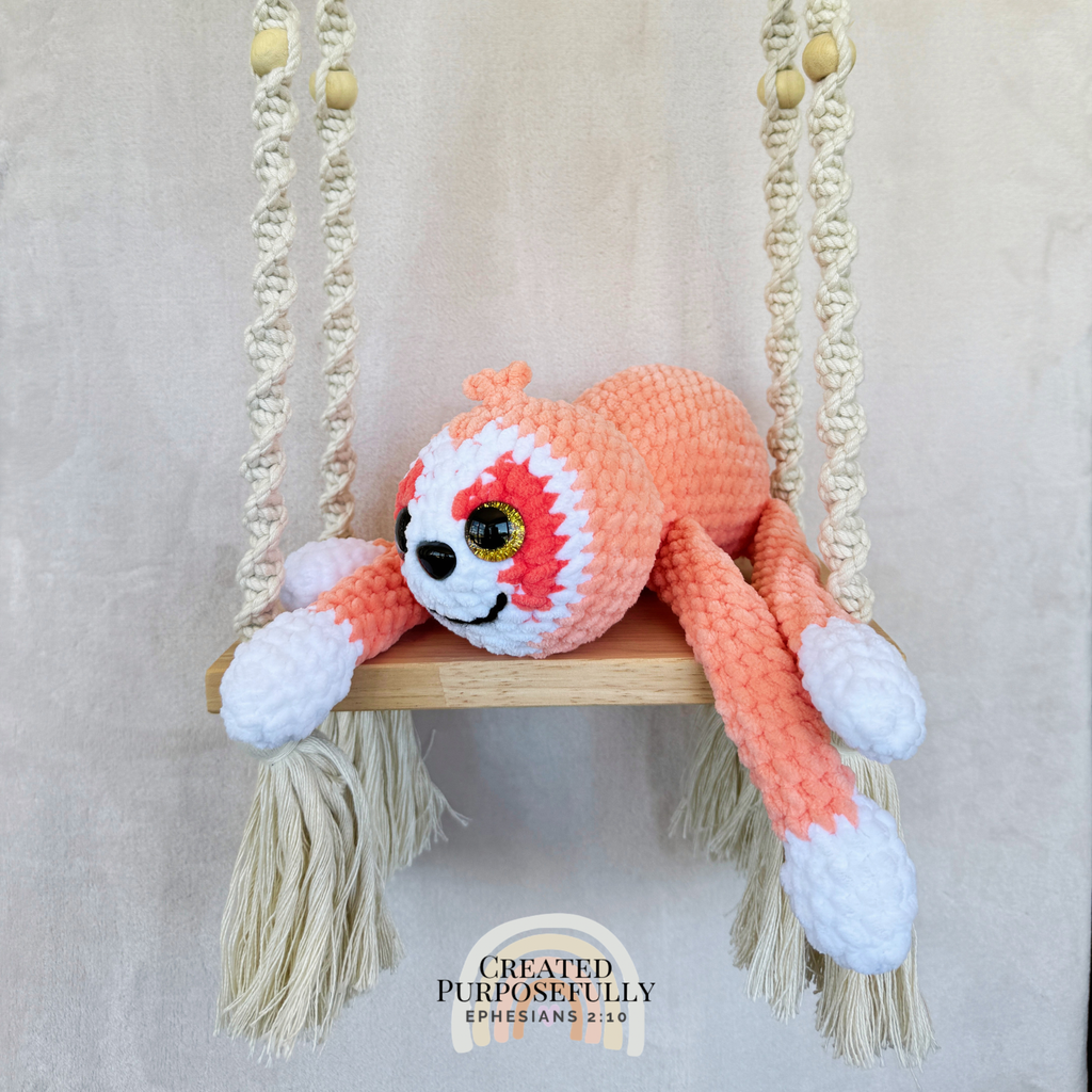 Handmade peach crochet sloth plush made with soft plush yarn and adorable handmade details