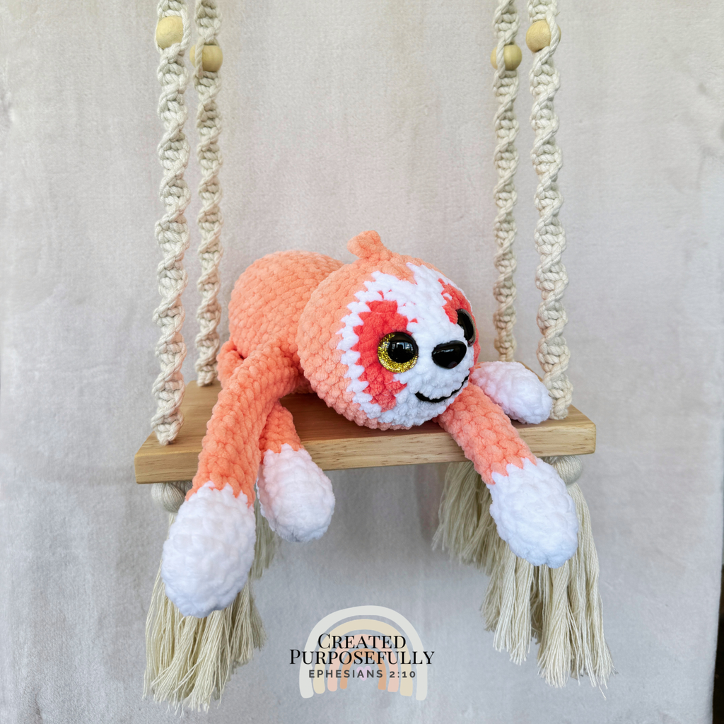 Handmade peach crochet sloth plush made with soft plush yarn and adorable handmade details