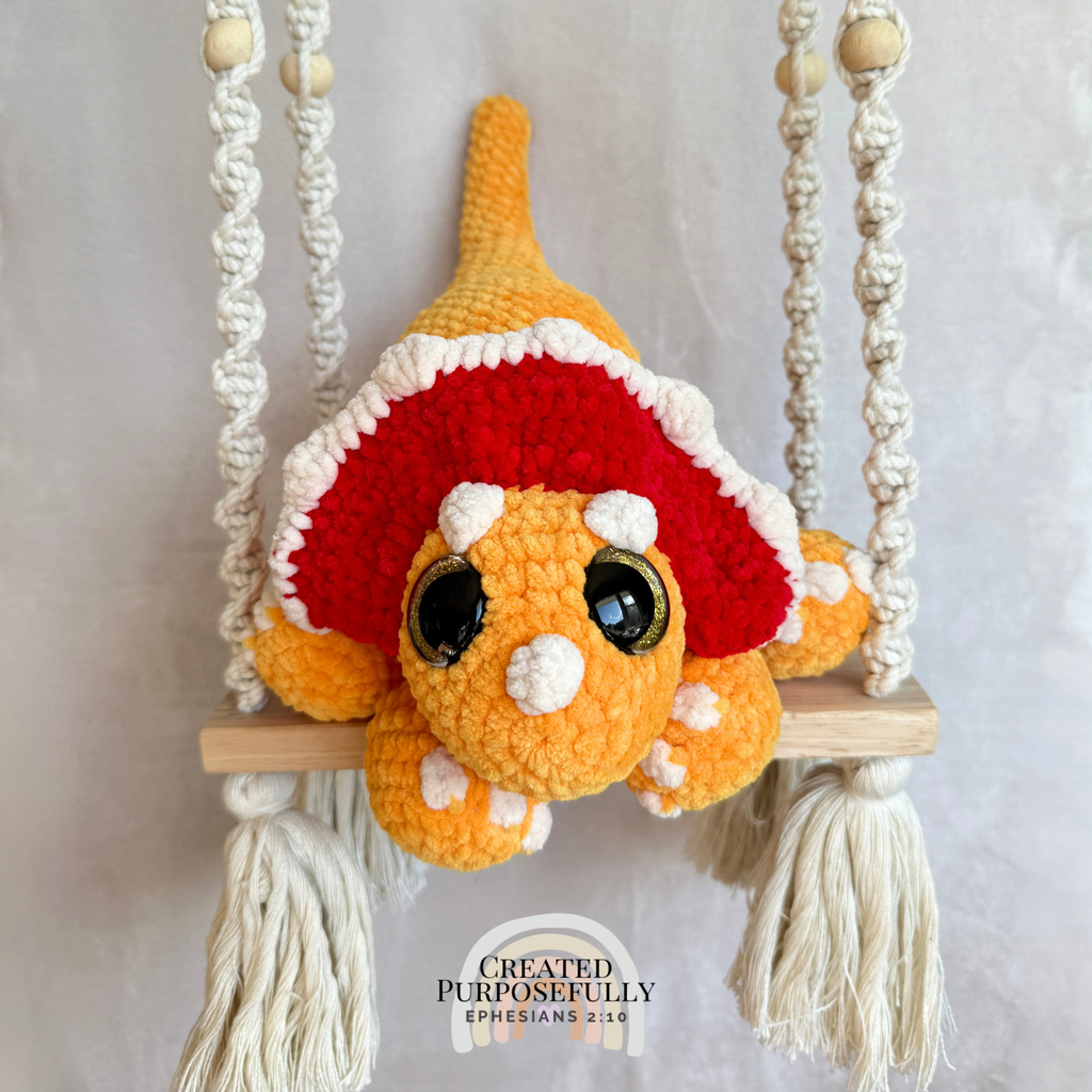 Handmade triceratops crochet plush made with soft plush yarn and adorable dinosaur details