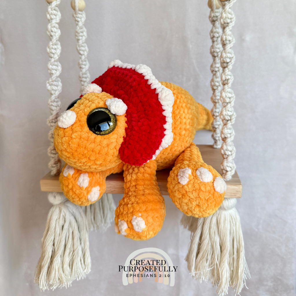 Handmade triceratops crochet plush made with soft plush yarn and adorable dinosaur details