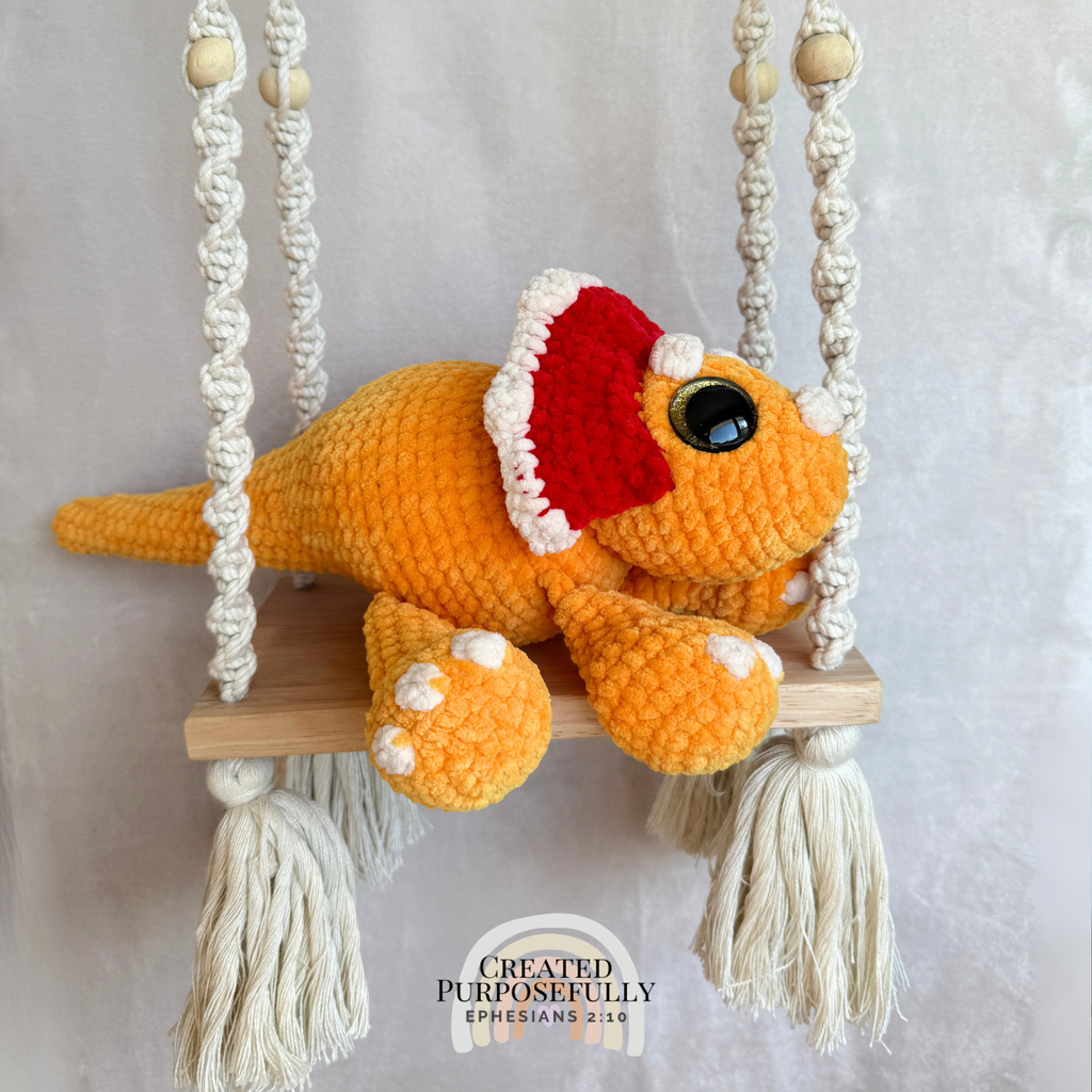 Handmade triceratops crochet plush made with soft plush yarn and adorable dinosaur details